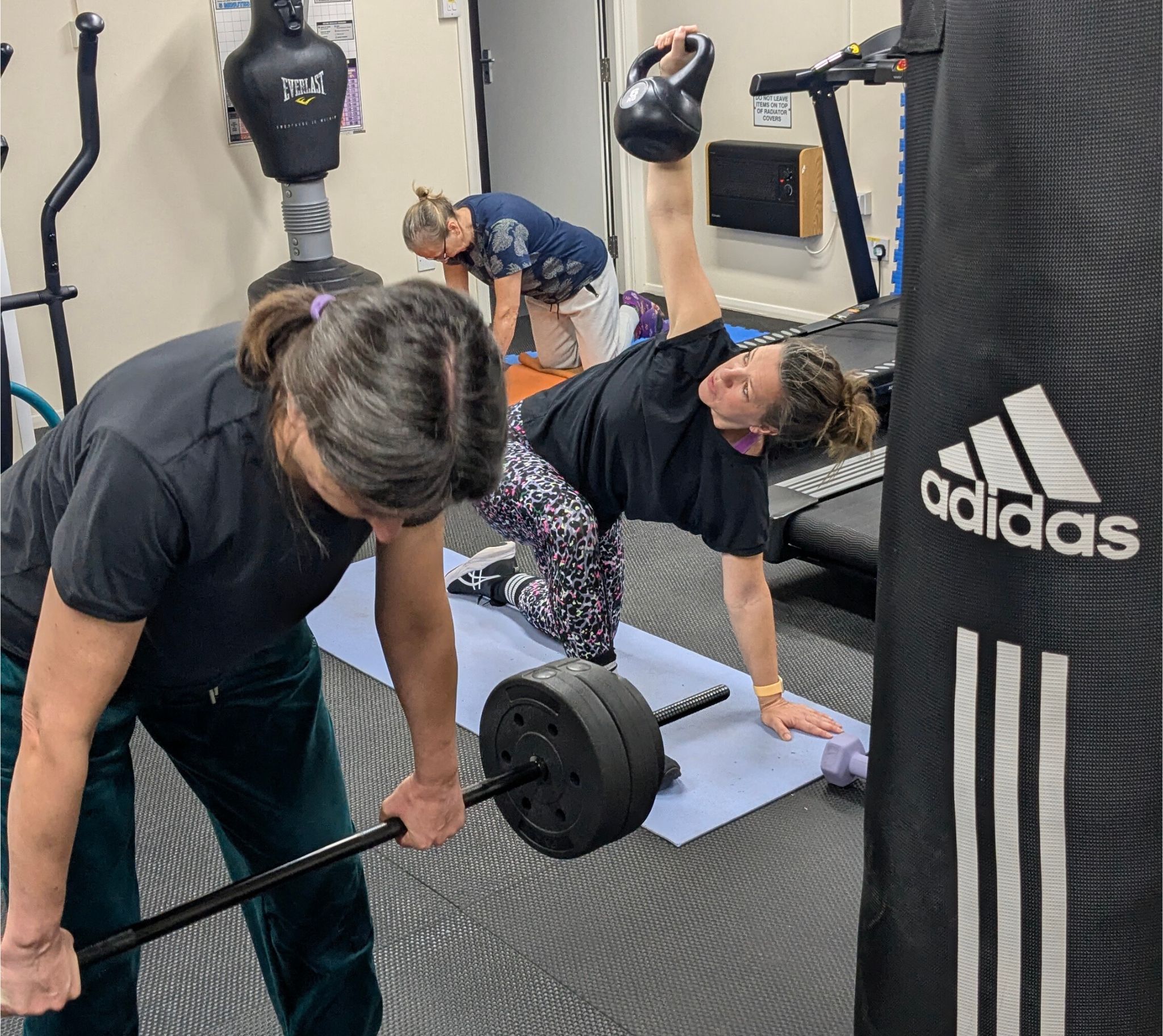3 women lifting weights in different positions